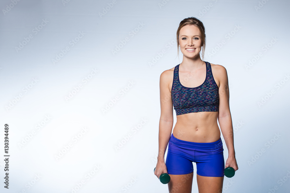 Female fitness model excersising with weights and floor routine Female fitness model excersising with weights and floor routine
