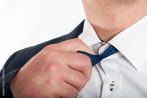 Man is loosening a tie after hard work