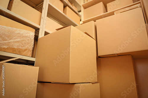 Modern warehouse full of cardboard boxes © Africa Studio