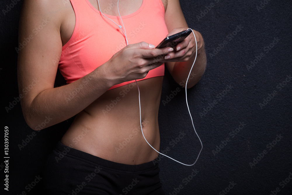 Sexy female fitness model with her smartphone Sexy female fitness model with her smartphone