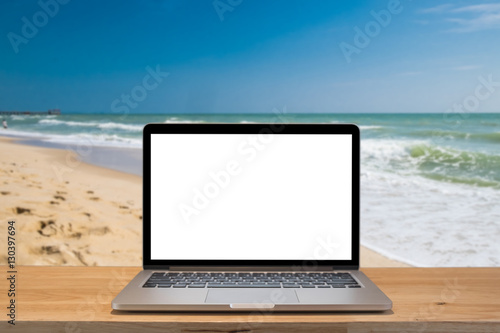 office on the beach, laptop with empty scree © Natee Meepian