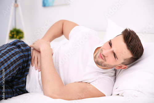 Young man feeling pain at home