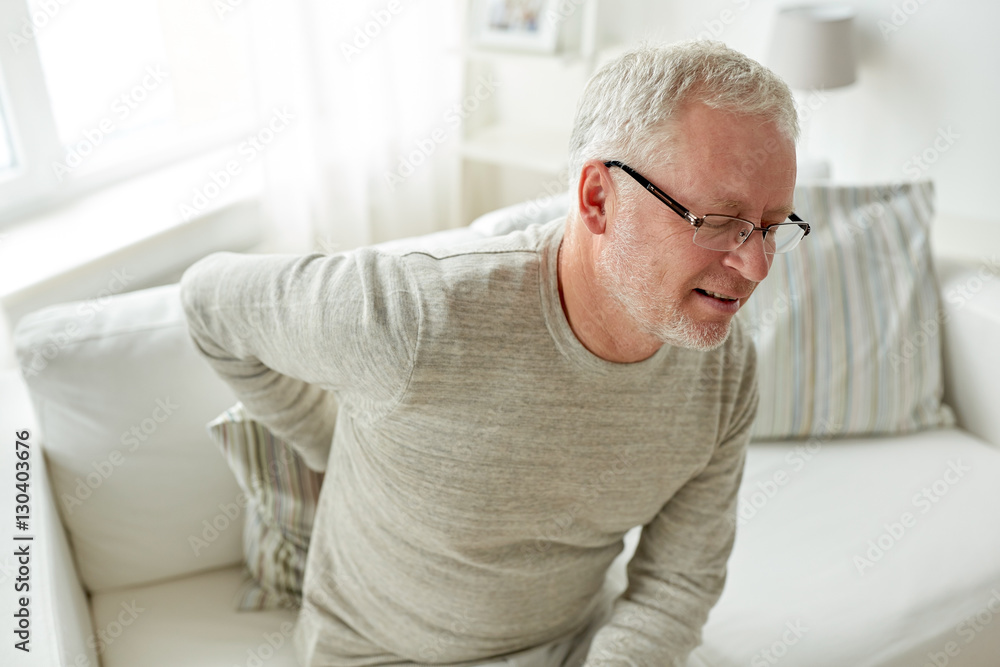 unhappy senior man suffering from backache at home unhappy senior man suffering from backache at home
