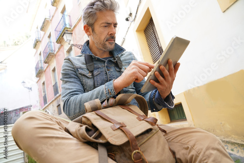  Tourist in historical town connected on digital tablet