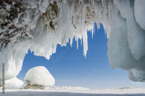 Tablou canvas Long blue icicles in the ice cave at coastal cliffs