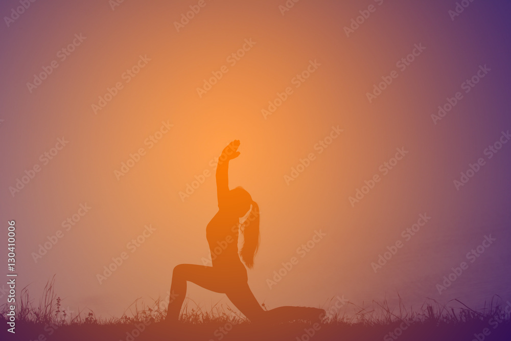 Silhouette women yoga in nature at the sky sunset, color of vintage tone