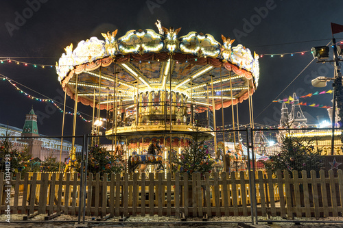 Illuminated retro carousel at night