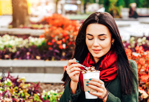 Long hair girl enjoying coffee dessert on the street photo