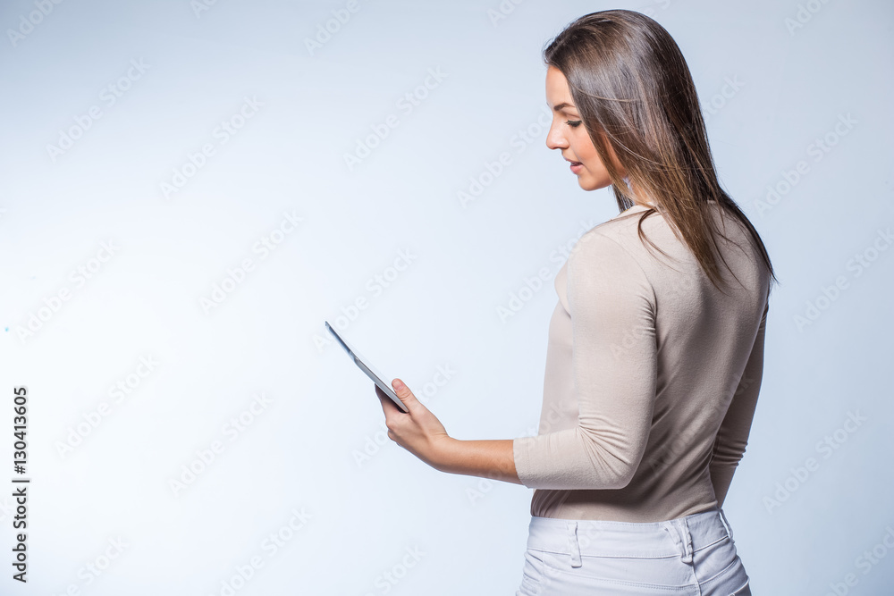 Young brunette business woman working on a tablet computer Young brunette business woman working on a tablet computer