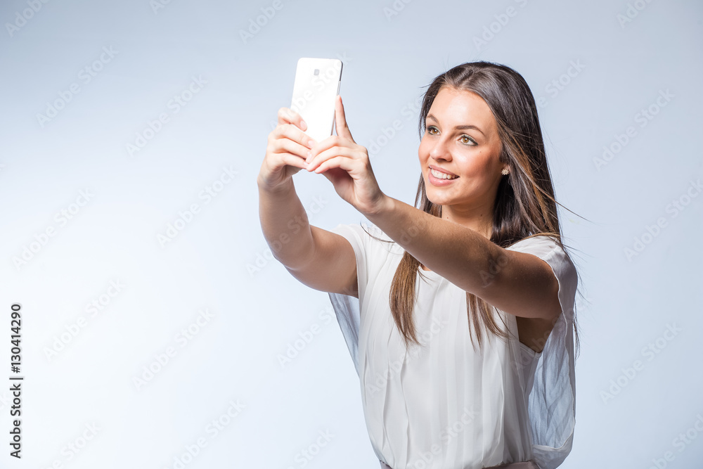 Pretty brunette business woman working on her smart phone planning business meetings or taking selfies. Pretty brunette business woman working on her smart phone planning business meetings or taking selfies.