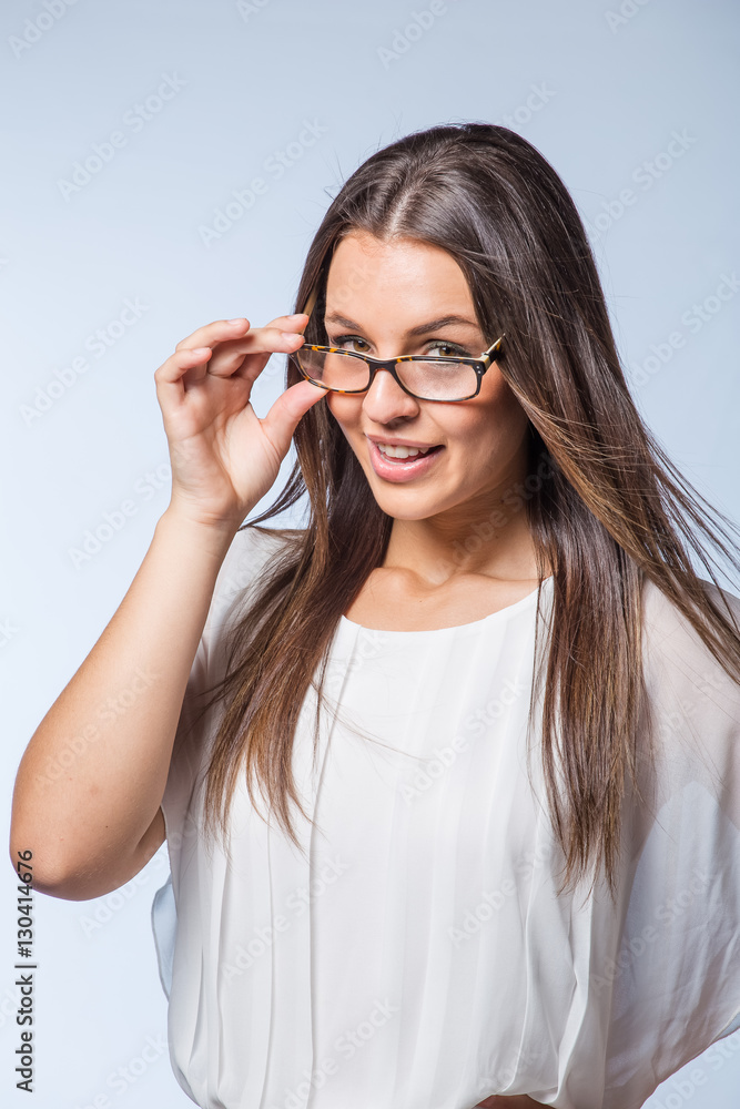Pretty Brunette business woman with glasses on a plain background Pretty Brunette business woman with glasses on a plain background
