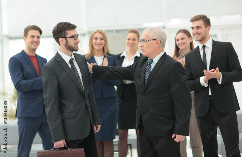 Mature businessman praising coworker during a meeting Mature businessman praising coworker during a meeting