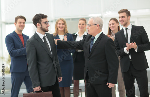 Mature businessman praising coworker during a meeting