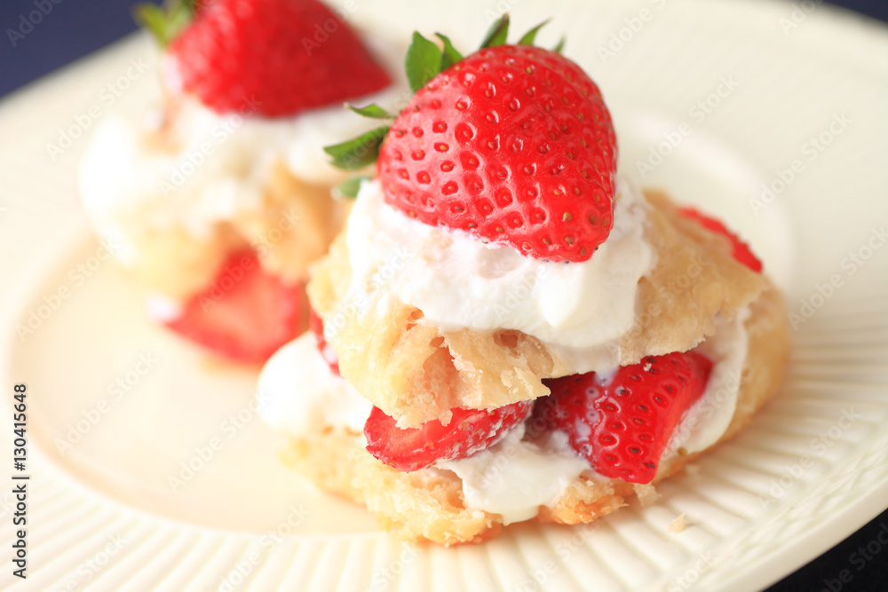 Miniature strawberry shortcakes with whipped cream and fresh berries Miniature strawberry shortcakes with whipped cream and fresh berries