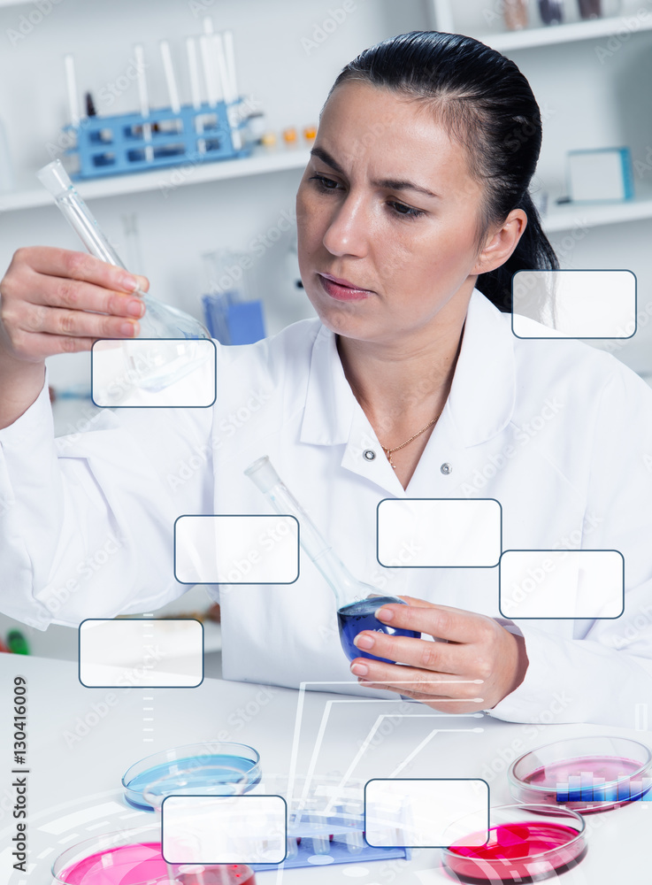 Young Female Scientist Analyzing Sample In Laboratory.laboratory assistant analyzing a sample Young Female Scientist Analyzing Sample In Laboratory.laboratory assistant analyzing a sample