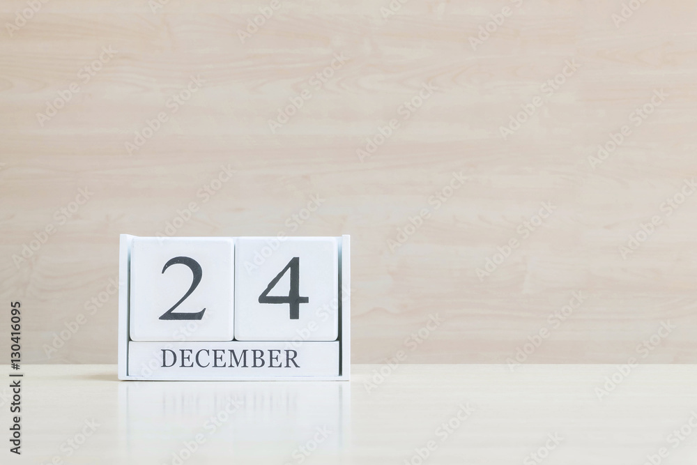 Closeup surface white wooden calendar with black 10 december wor Closeup surface white wooden calendar with black 10 december wor