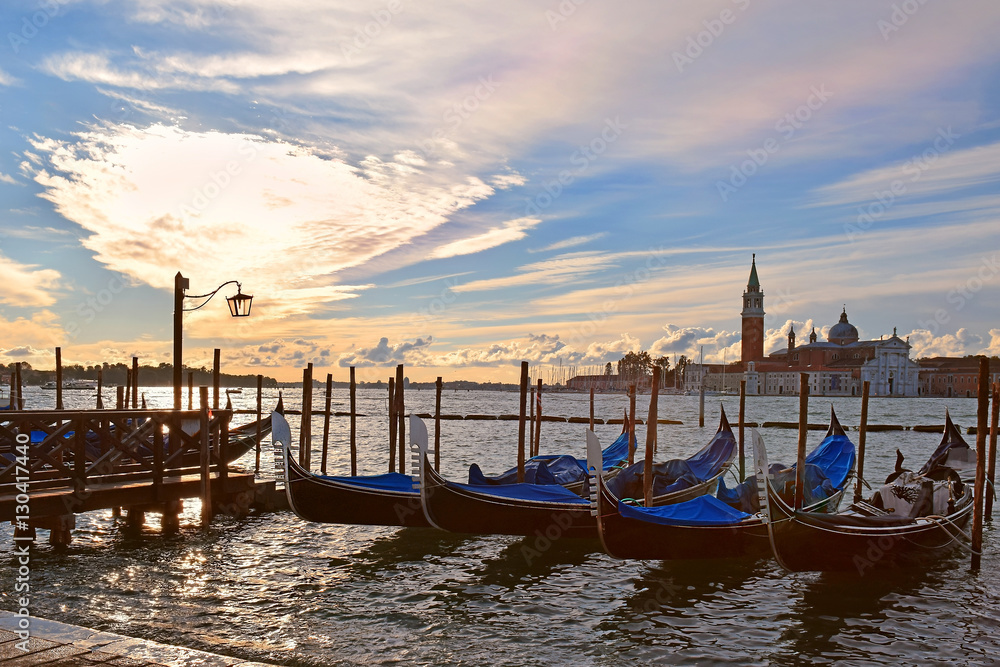 gondolas moored on the Grand Canal in Venice, evening