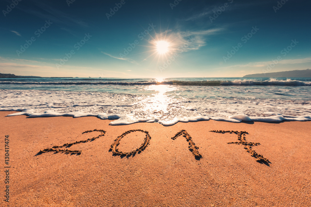 Happy New Year 2017 concept on the sea beach; sunrsie shot Happy New Year 2017 concept on the sea beach; sunrsie shot