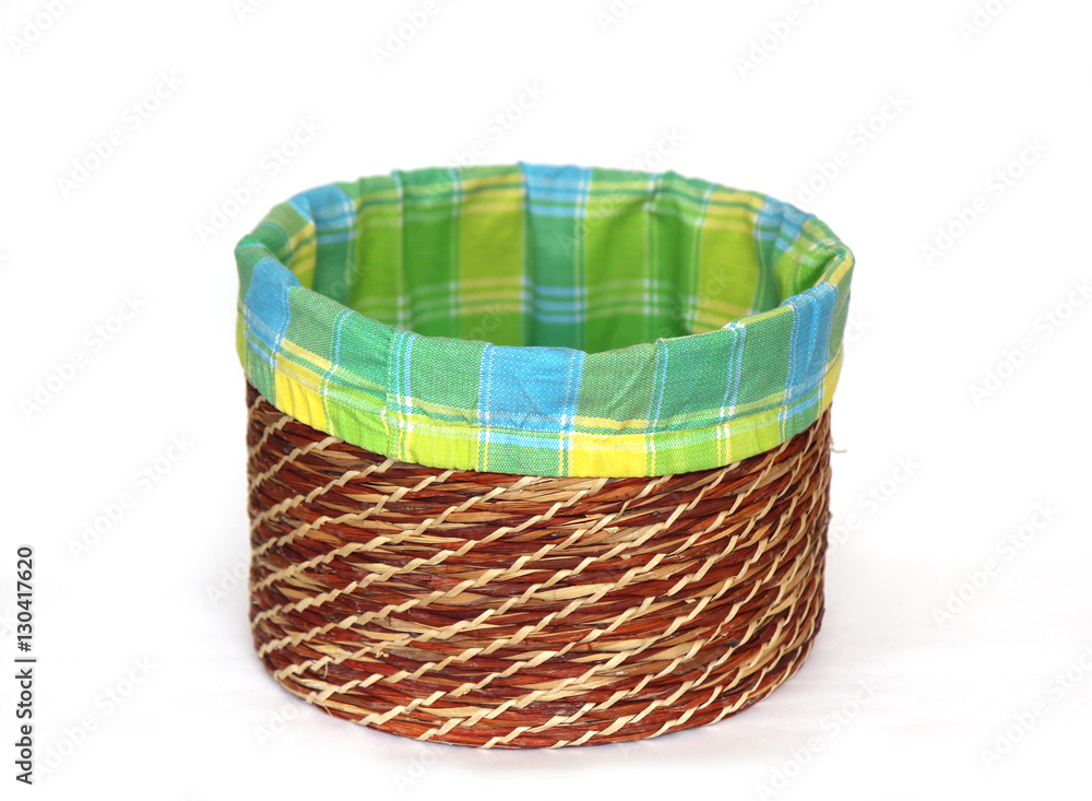 empty wicker basket with coloured cloth on a white empty wicker basket with coloured cloth on a white