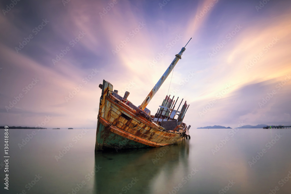 An old shipwreck or abandoned shipwreck. , Wrecked boat abandoned stand on beach or Shipwrecked off the coast of Thailand.