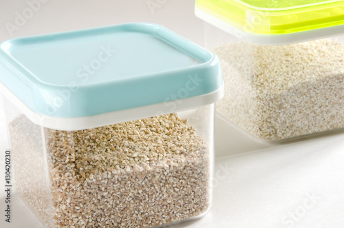 Food storage. Food ingredients (cut wheat and barley) in plastic containers. Selective focus.
