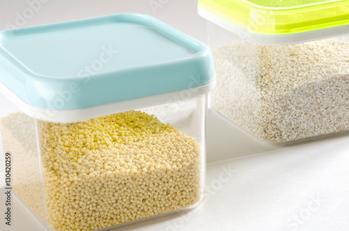 Food storage. Food ingredients (millet and barley) in plastic containers. Selective focus.