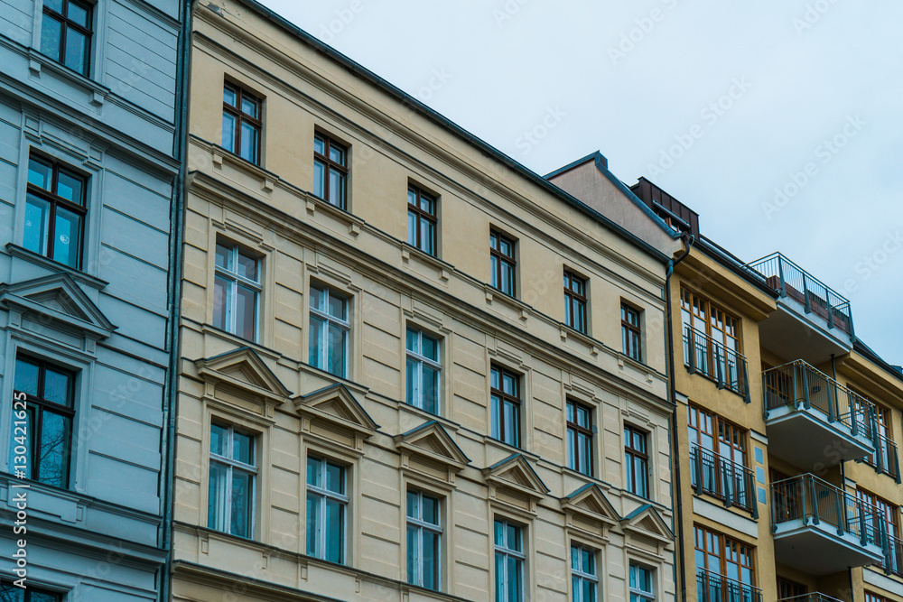 Fototapeta premium white, yellow and orange facades of houses