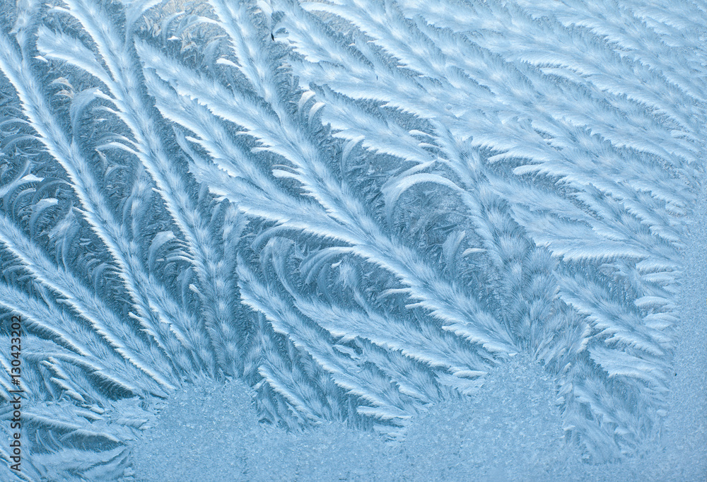 Frosty patterns on glass in winter Frosty patterns on glass in winter