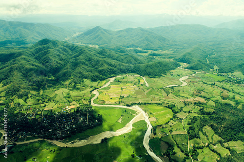 Green landscape with river and mountain. View from above.
