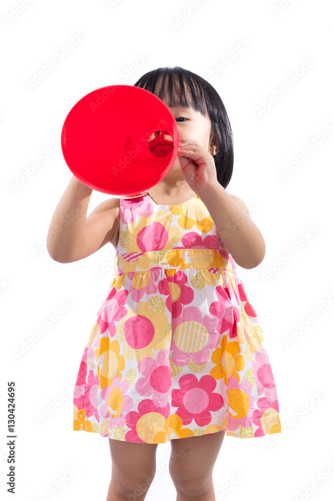 Happy Asian Chinese little girl holding retro loudspeaker