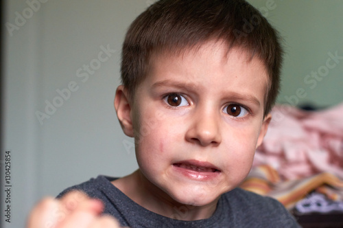 Konstfotografi Aggressive child is looking hostilely in the camera.