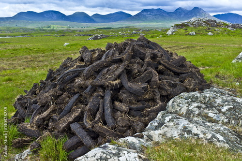 Stacked peat in turf bog on the Old Bog Road near Roundstone, Connemara, County Galway photo