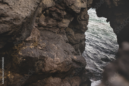 Deep blue sea waves splashing volcanic rocks, Catania, Sicily co