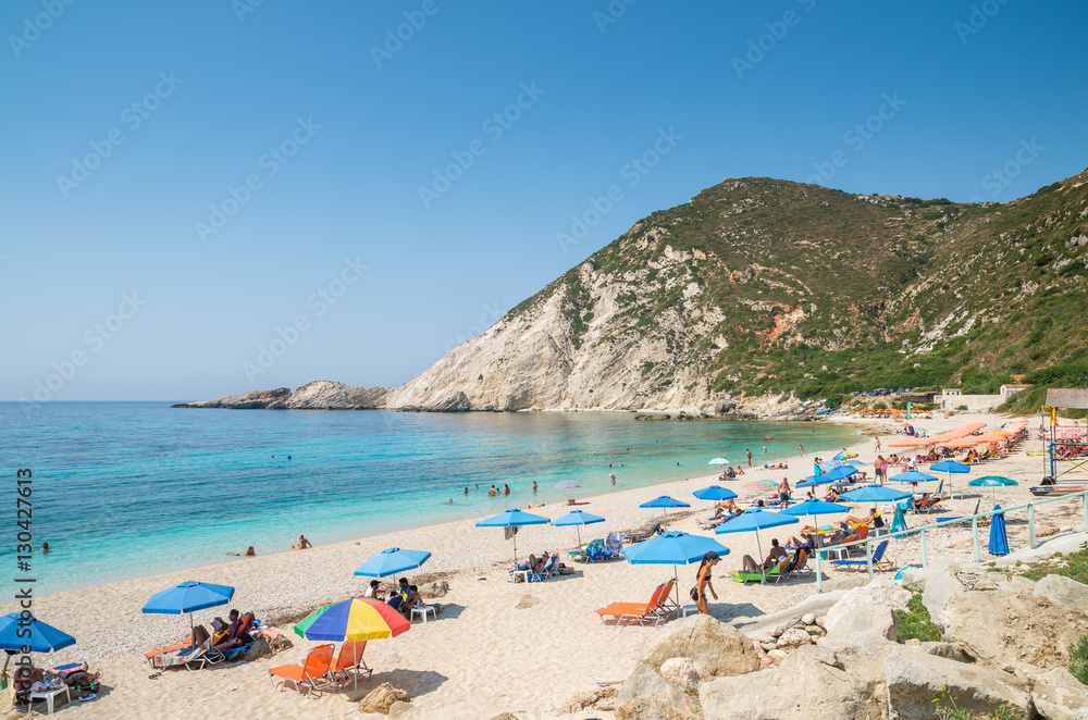 KEFALONIA ISLAND, GREECE - August 8, 2015: People relaxing at the beach of Petani, Kefalonia island, Greece.