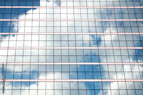 Windows of office buildings with clouds mirrored on them. Awesome business background.
