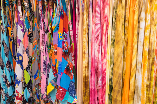 Rows of colourful batik hanging at a market stall in Bangkok, Thailand..