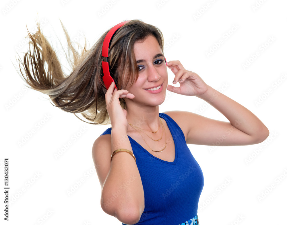 Beautiful teenage girl listening to music on wireless headphones with ...