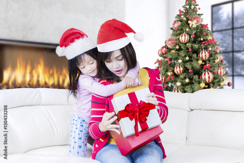 Asian mother and child open christmas gift Asian mother and child open christmas gift