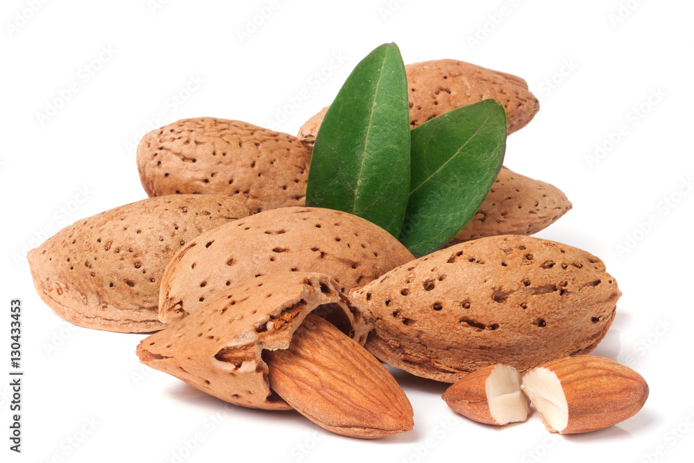 heap of almonds in their skins and peeled with leaf isolated on white background heap of almonds in their skins and peeled with leaf isolated on white background