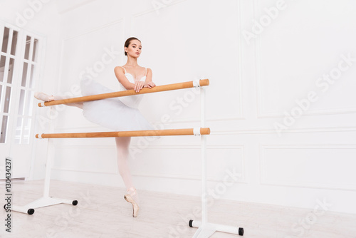 Majestic ballerina doing stretching exercises