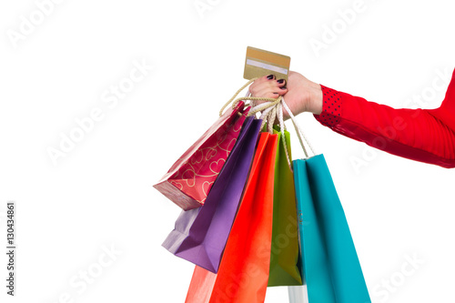 Colourful shopping packages and banking card in female right hand