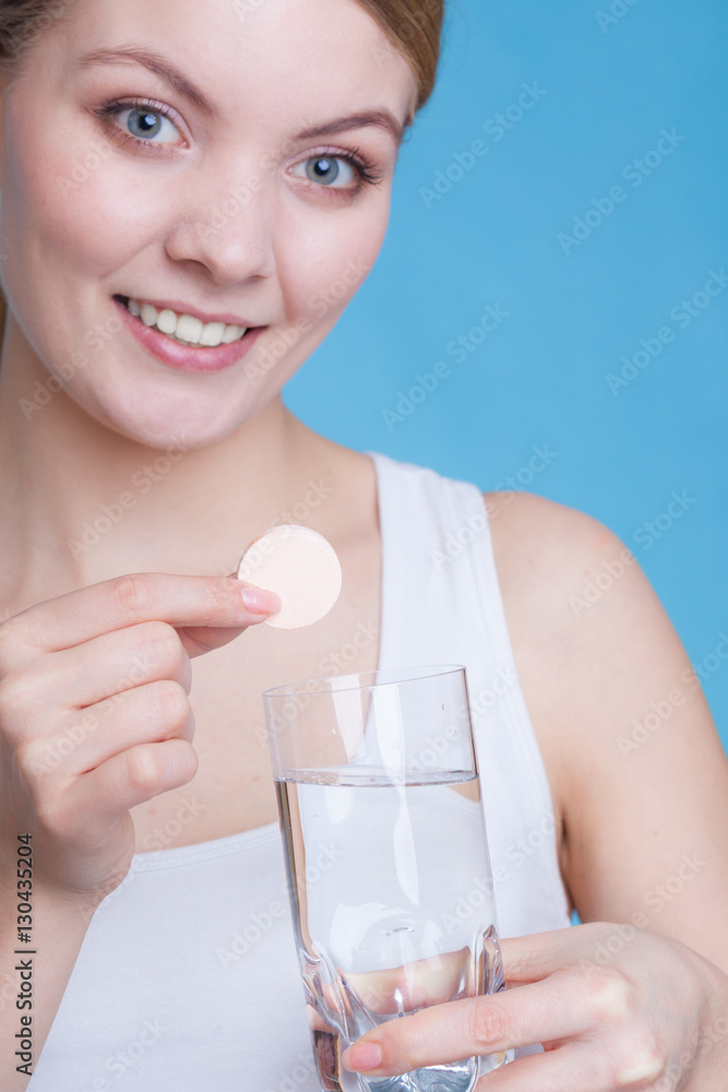 Woman holding glass with water and effervescent tablet Woman holding glass with water and effervescent tablet