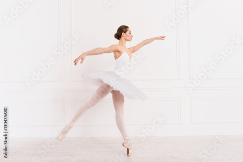 Amazing ballerina standing in semi position