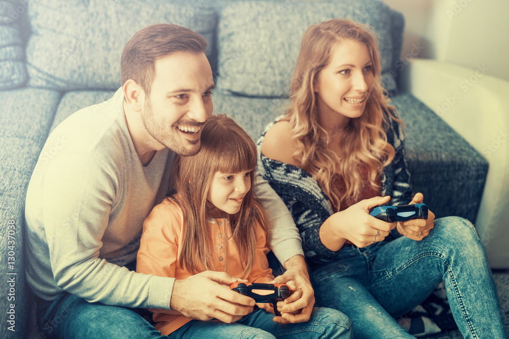 Happy young family playing video games