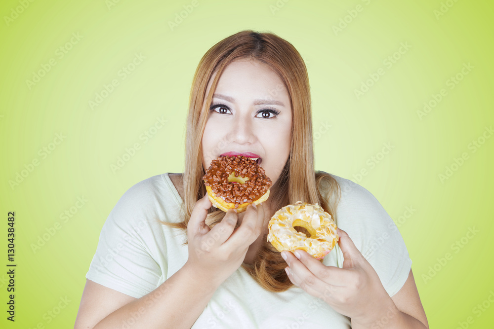 Obese woman eats two donuts