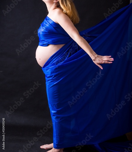 Yong pregnant woman in colorful fabric.