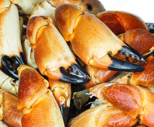 Pile of orange boiled with black tip, crab claws, at closeup