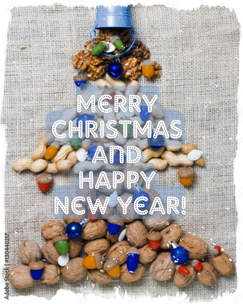 Merry Christmas and Happy New Year 2017, Christmas tree made from different types of nuts, cookies. 