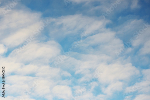 white clouds against the blue sky on a sunny winter day in the evening.