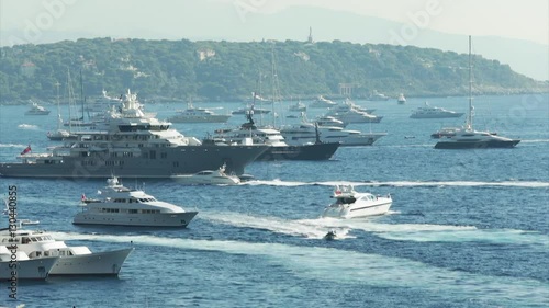 World Fair MYS Monaco Yacht Show, Port Hercules, luxury megayachts, many shuttles, taxi boat, presentations, Journalists, boat traffic, Azur water, aerial view, mountains on background, perspective photo